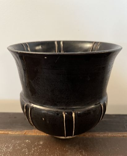 Vase in black glazed ceramic, the horned...