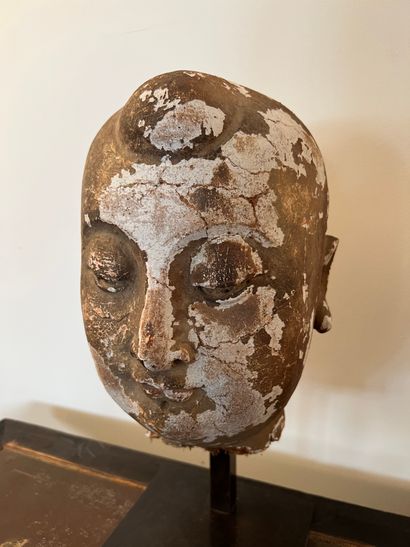 Head of Buddha in wood and stucco with golden...