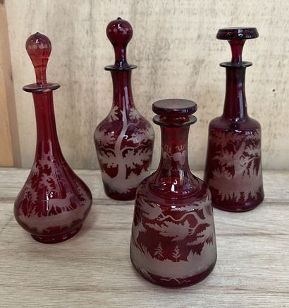 Set of four Bohemian red lined crystal bottles...