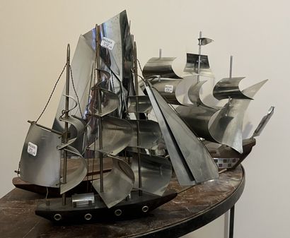 Six sculptures of sailing ships, the sails...