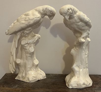 Pair of parrots in cream enamelled earthenware....