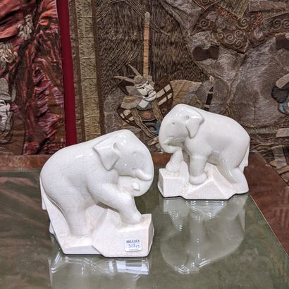 Pair of beige enameled earthenware bookends...