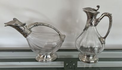Two crystal decanting ewers, the pewter mounts....