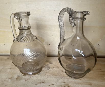 Two glass carafes, one blown, the base, handle...