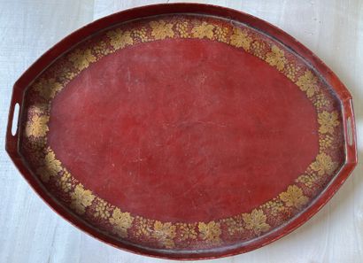 Large oval tray in red lacquered sheet metal...