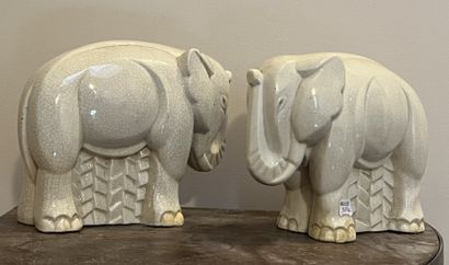 Pair of groups of elephants, the trunk raised,...