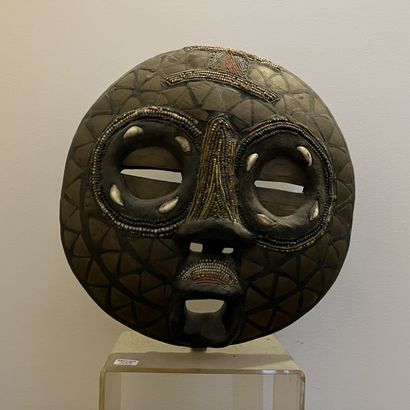 African mask in carved wood applied with...