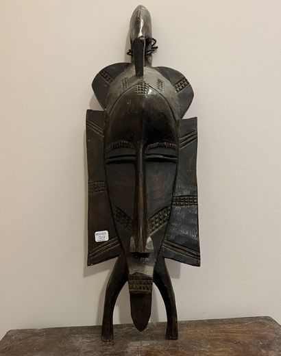African mask in carved wood with scarification...