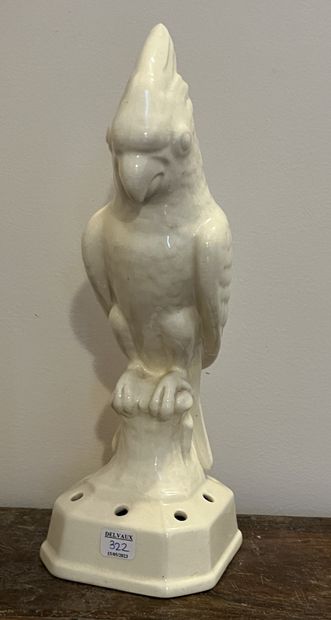 Parrot in cream glazed earthenware, the base...