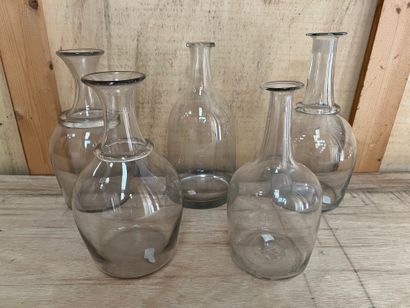 Set of five blown glass decanters, the neck...