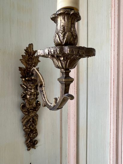 Pair of sconces in chased cast bronze, featuring...