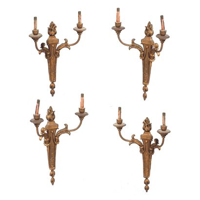 Suite of four two-light sconces in gilded...