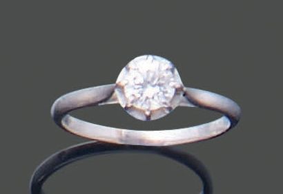 Platinum ring set with a modern-cut diamond,...
