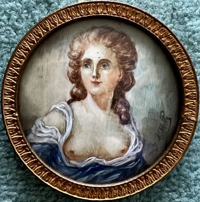 Round miniature depicting a young woman with...