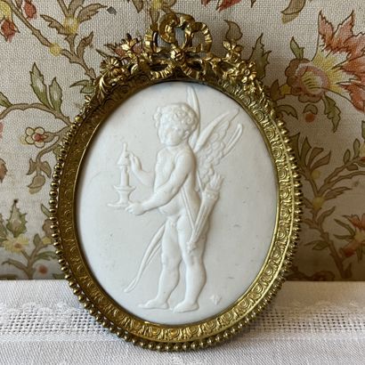 Bisque medallion depicting Amour extinguishing...