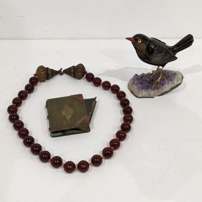 Trinkets: statuette of a bird in tiger's...