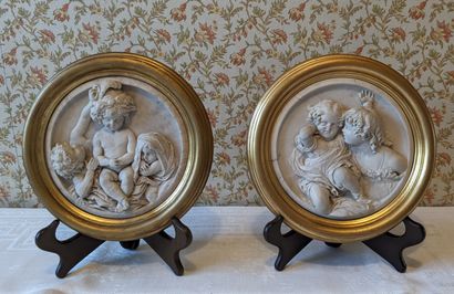Pair of round medallions in marble composition,...