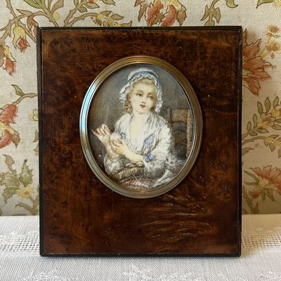 Oval miniature depicting a young girl with...