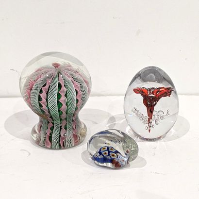 Set of glass paperweights, the first with...