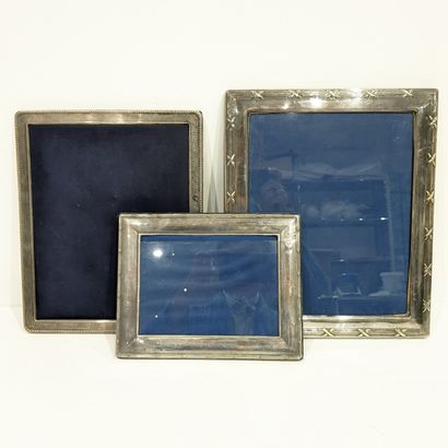Three silver-plated photograph frames, decorated...