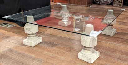 Large coffee table, square glass top resting...