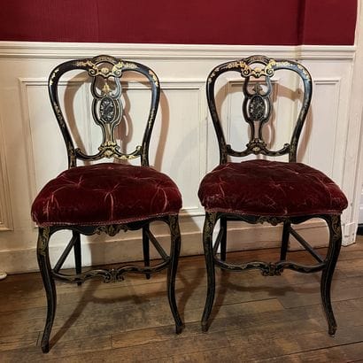 Pair of chairs in blackened wood with gilded...
