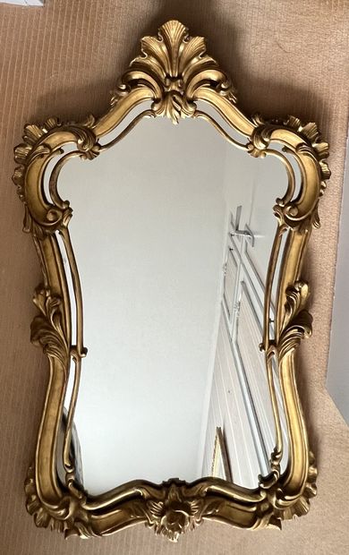 Mirror in gilded wood style, the bezel decorated...