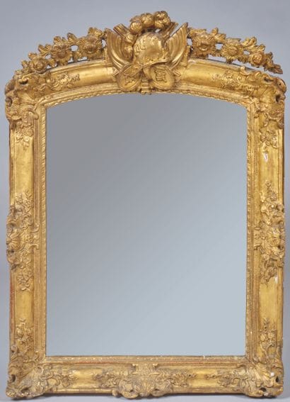 Mirror with gilded wood surround, the curved...