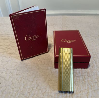 CARTIER. Gold-plated oblong lighter with...