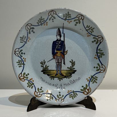 Earthenware plate decorated with a grenadier,...