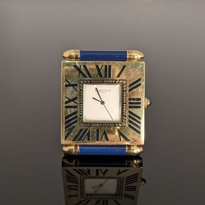 CARTIER. Folding travel alarm clock in gilt...