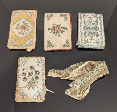 Set in pearl: four notebook covers with stylized...