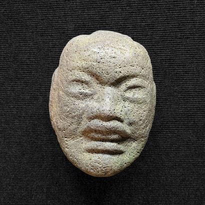 Basalt head carved in the Asian style. H....