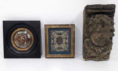 Small reliquary in a blackened wood frame....