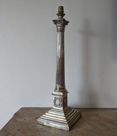 Silver-plated lamp base featuring a fluted...