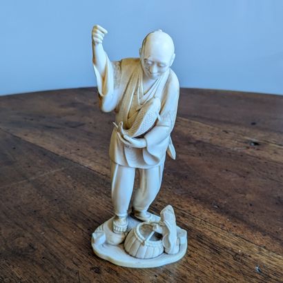Small okimono representing a fisherman. Signed....