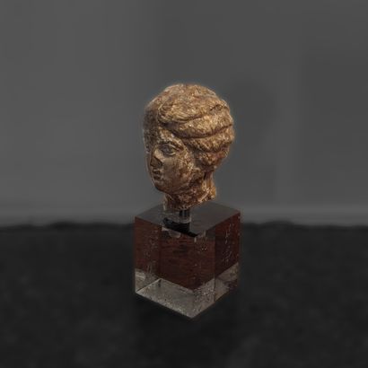 In the Tanagra style. Terracotta head. H....