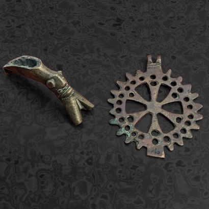 A patinated bronze pendant (?) with a pierced...