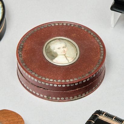 Boîte ronde en laque rouge piqué de frises...