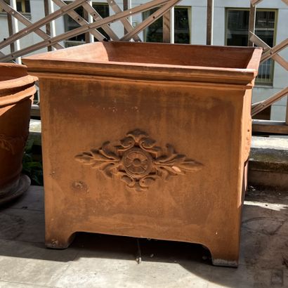 A set of terracotta flower pots: two in the...