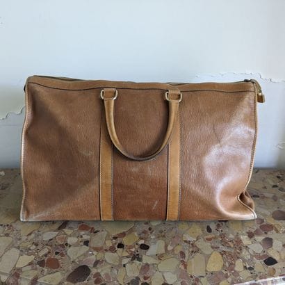 Christian DIOR. Havana leather travel bag....