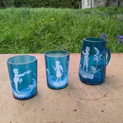 Small pitcher and two tumblers in blue glass,...