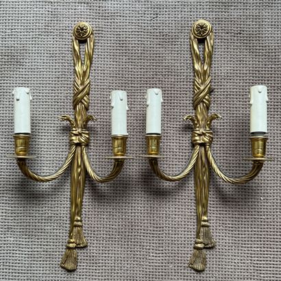 Pair of bronze sconces decorated with passementerie...