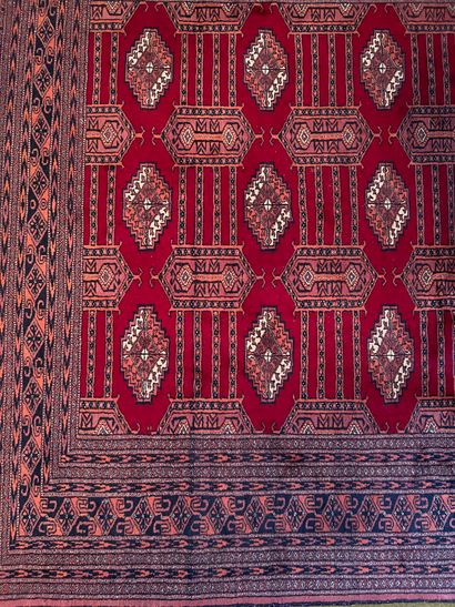 Wool carpet with guhls on a red background....