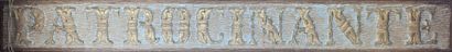 Patinated wood panel carved with letters...
