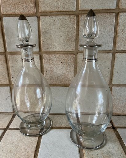 A pair of egg-shaped decanters with silver...