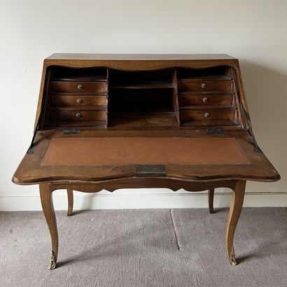 Varnished wood sloping desk, the flap revealing...