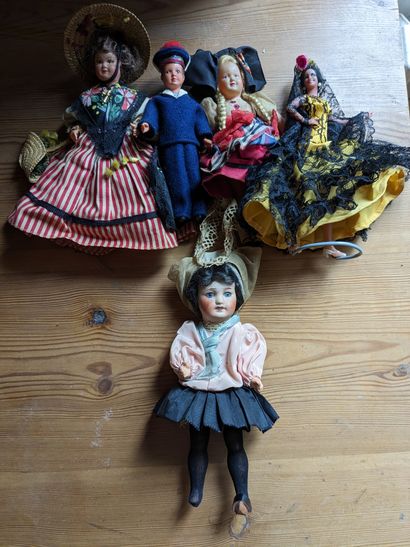 Porcelain-headed doll in regional costume....