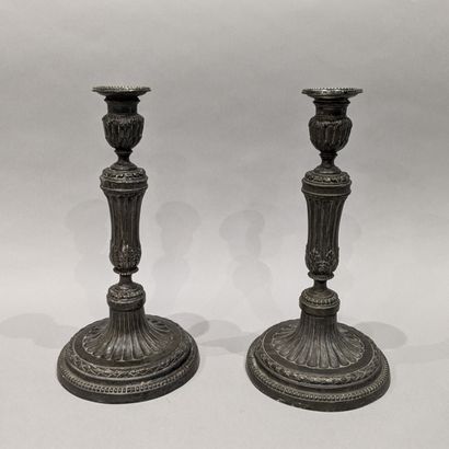 Pair of metal torches, decorated with fluting,...