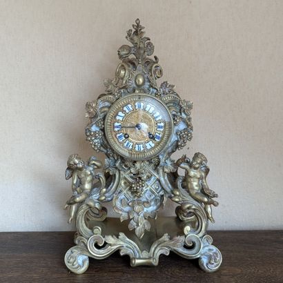 Patinated bronze clock decorated with vine...